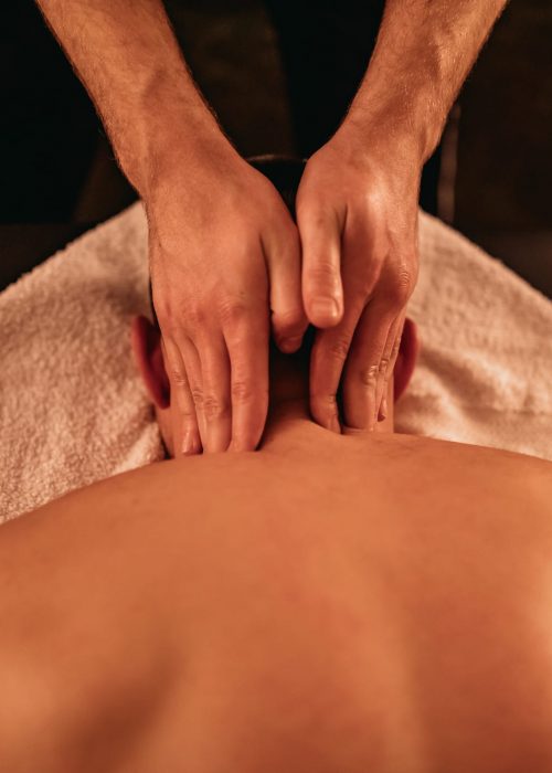 Young Caucasian having laying on stomach and having a Massage.